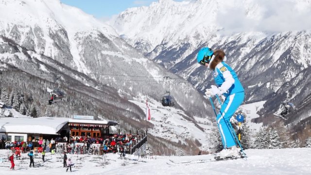 Woman the skier stands near point of hire of equipment