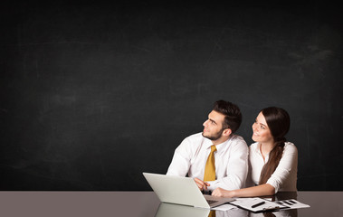 Business couple with black background