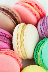 colorful macarons on wooden surface