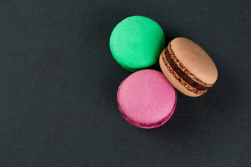 macarons on black stone background