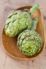 artichokes on wooden surface