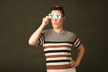 Silly youngster looking with hand drawn eye paper