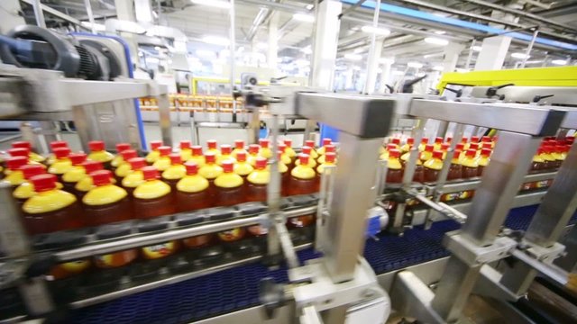 Top view of conveyor with bottles with fresh light beer 