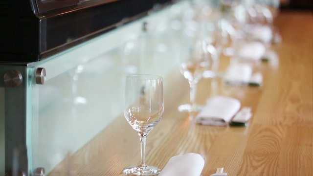 Many glasses on table at cozy cafe with modern interior
