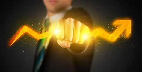 Business person holding a hot glowing upright arrow