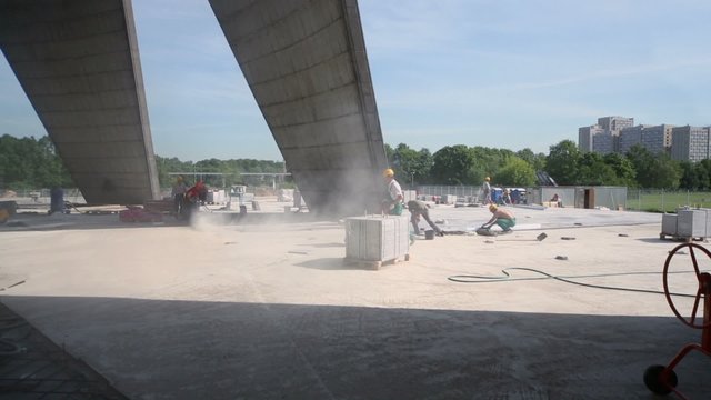 Several pavers make pavement at construction site