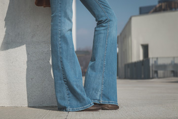 Detail of a girl posing in an urban context