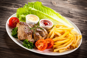 Grilled steak, French fries and vegetables