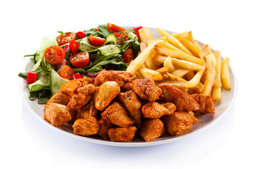 Fried chicken nuggets, French fries and vegetables