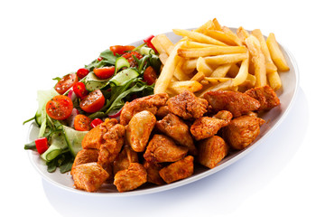 Fried chicken nuggets, French fries and vegetables