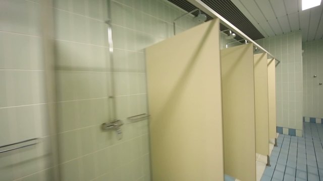 Large public shower room with several of shower enclosures