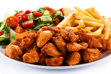 Fried chicken nuggets, French fries and vegetables