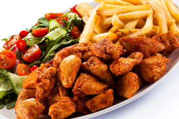 Fried chicken nuggets, French fries and vegetables