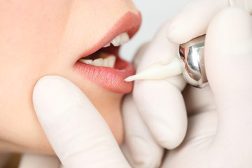 Cosmetologist making permanent makeup, close up