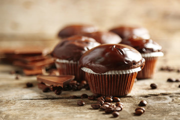 Tasty homemade chocolate muffins on wooden table