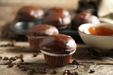 Tasty homemade chocolate muffins on wooden table