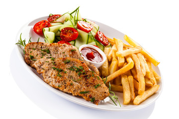 Pork chops, French fries and vegetables