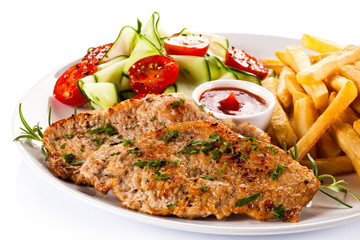 Pork chops, French fries and vegetables
