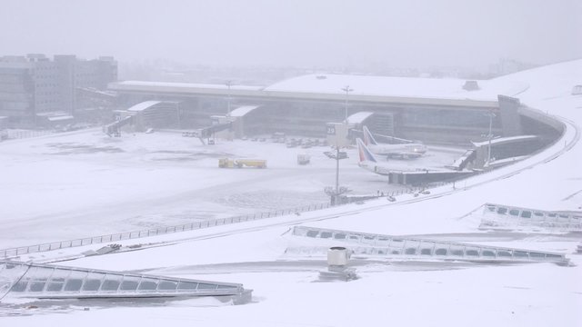 Plaines being moved from hangar on snowy day. Timelapse