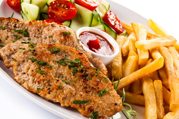Pork chops, French fries and vegetables