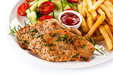 Pork chops, French fries and vegetables