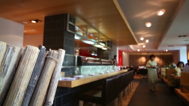 Dry bamboo and waiters go in cozy cafe with modern interior