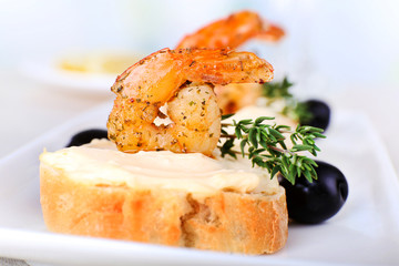 Appetizer canape with shrimp and olives
