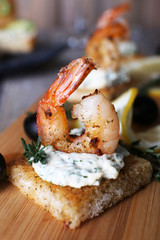 Appetizer canape with shrimp and olives