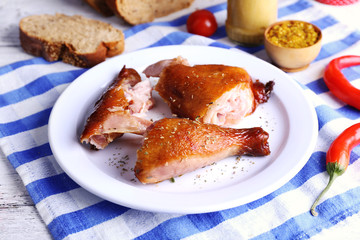Smoked chicken with vegetables on plate on table close up