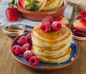 pancakes with fresh raspberries and  butter .