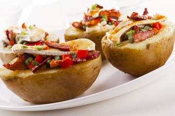 Baked potatoes stuffed with bacon, served with camembert