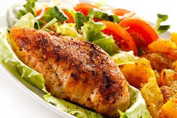 Fried chicken fillet, boiled potatoes and vegetable salad