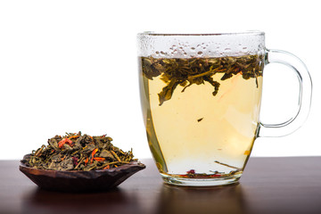 Aromatic antioxidant green tea on wooden board, isolated backgro