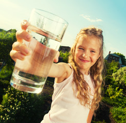 Girl holding glass with water