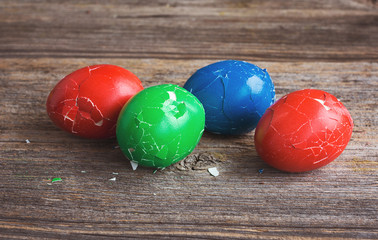 Broken Easter eggs on wooden background