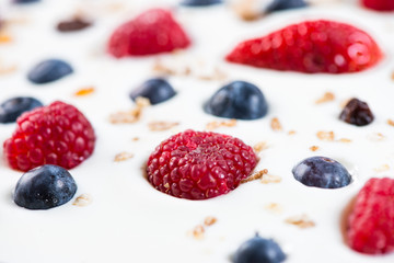 fresh berries fruits isolated on greek yogurt, healthy backgroun