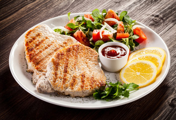 Grilled steaks and vegetable salad