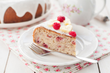 Banana Cake with Sugar Glaze Topped with Raspberries and Banana