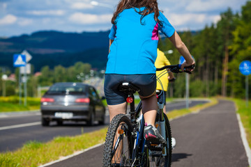 Healthy lifestyle - teenage girl and boy biking