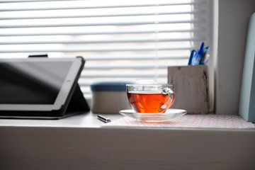 PC tablet, notebook and cup of tea