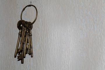 vintage keys hanging on concrete wall