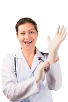 cheerful woman doctor puts on a rubber glove