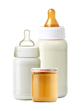 baby milk bottles and jar of baby puree isolated on white