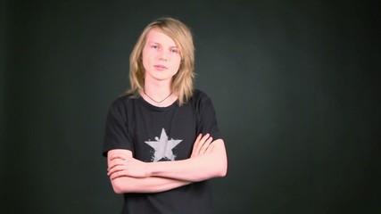 Boy in shirt with star stand in photo studio and then walks away
