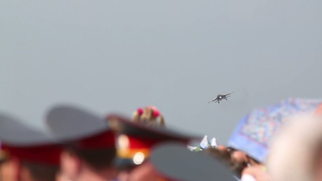 Heads of spectators and Su-35 (russian pilot) on air show
