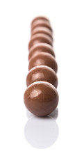 Chocolate balls with over white background