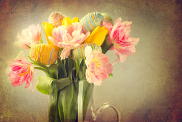 Easter. Tulip flowers bouquet decorated with colourful eggs
