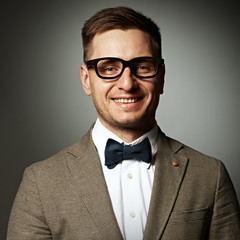 Confident nerd in eyeglasses and bow tie