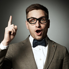 Confident nerd in eyeglasses and bow tie