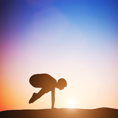 Woman in crane pose yoga pose meditating at sunset. Zen